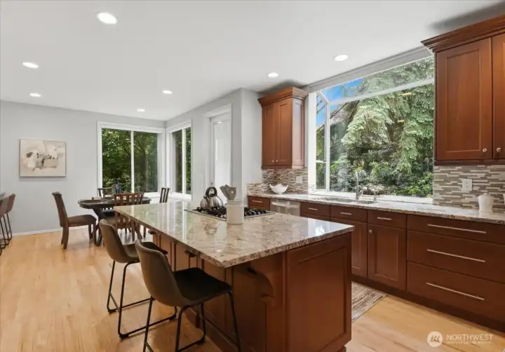 The island has breakfast bar seating. Large garden window looking out to the private back yard. The island has breakfast bar seating. Large garden window looking out to the private back yard.