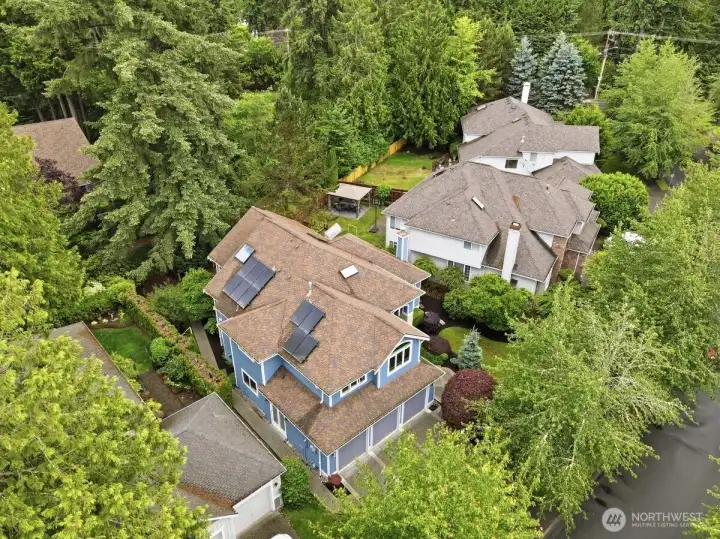 Home is surrounded by luscious greenery. Solar panels help keep your energy costs down year round. Home is surrounded by luscious greenery. Solar panels help keep your energy costs down year round.