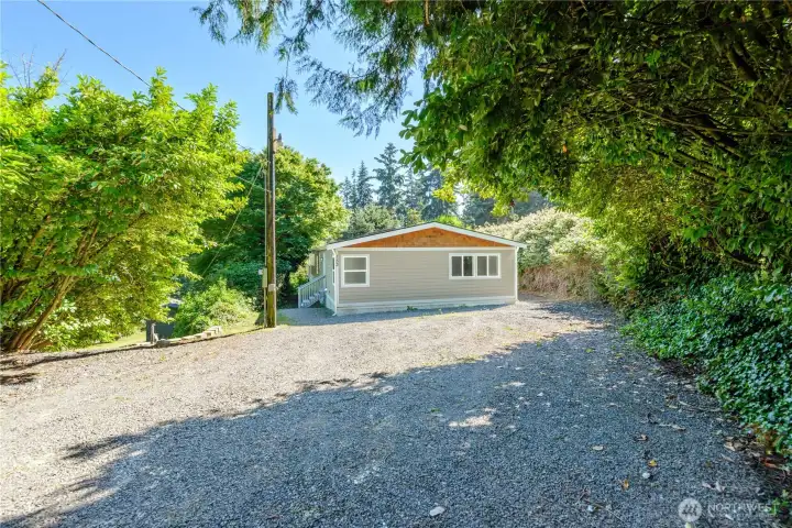 Expansive parking area for multiple vehicles and water toys or even an RV.