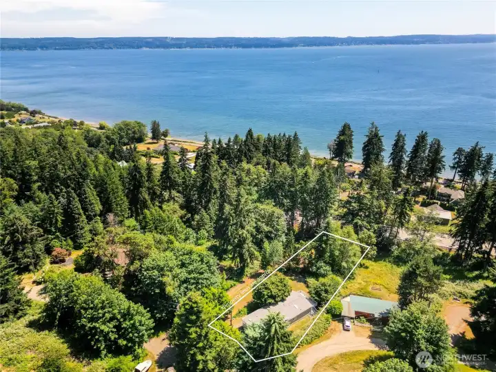 Aerial view with approximate property lines highlighting the spacious homesite in a wooded setting near the hood canal bay.