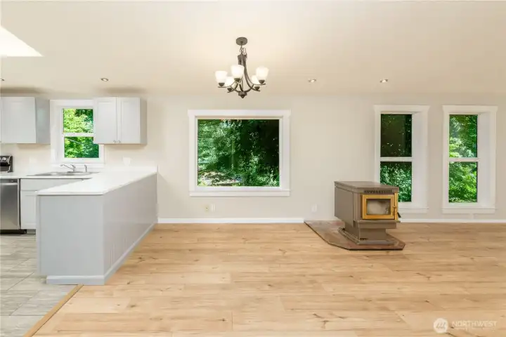 Bright dining area with large picture windows, a skylight, and easy access to the kitchen for everyday living and entertaining.
