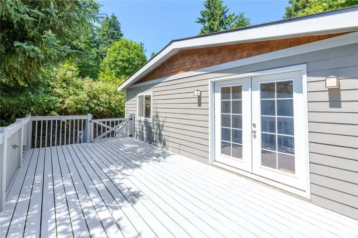 Step outside onto the expansive freshly painted deck, where French doors create a seamless connection to the indoors and peaceful woodland surroundings provide a private backdrop for morning coffee, outdoor dining, or relaxing in the fresh Pacific Northwest air.