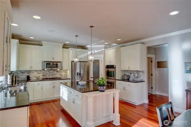 Chef's kitchen with large island, double ovens, new 6 burner stove and refrigerator.