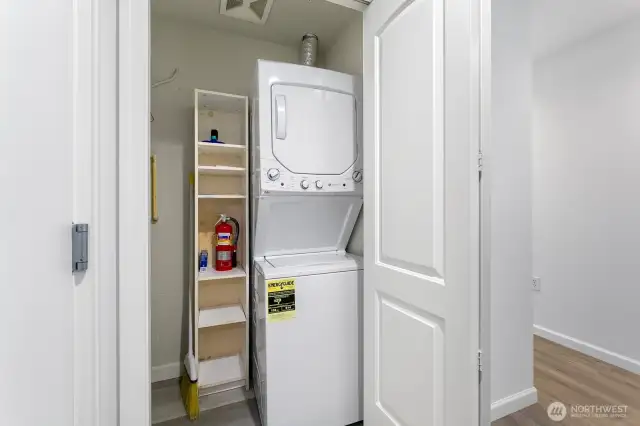 Washer & Dryer with a bit of storage in here as well. Water heater is to the left of the W/D (not pictured). Primary bedroom is off to the right of this photo.