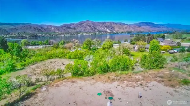 Enjoy these gorgeous Lake Osoyoos and mountain views and year-round access on your 2.78 acre property!