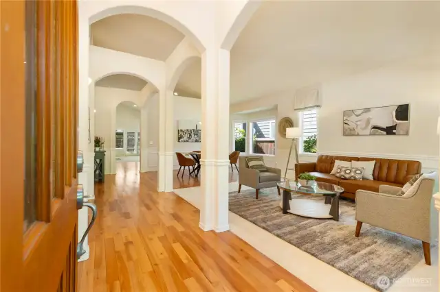 Entry with wooden floor to open formal living room to host your guests