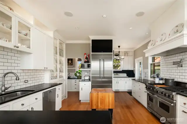 Custom cabinetry for abundant storage, luxe appliances including Viking range, 2 Miele dishwashers, Thermador refrigerator, pot filler, two sinks and built-in china cabinet.