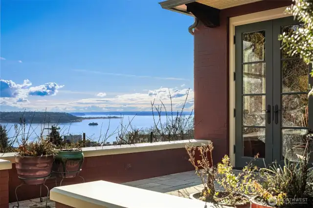 Glass panel doors enable easy indoor/outdoor use and access to dining patio, large view patio with fireplace and BBQ and step down to level backyard.
