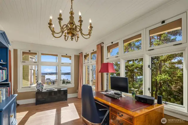 Huge remodeled office with three walls of double pane windows.