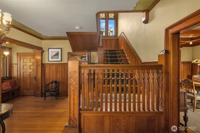 Gracious entry foyer with original millwork, pocket doors, original light fixture plus large coat closet and entry bench. The large glass front door is flanked by leaded glass side lights.