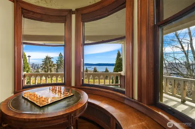 Enjoy the privacy and quiet of this enchanting property from this nook with built-in bench and curved windows.