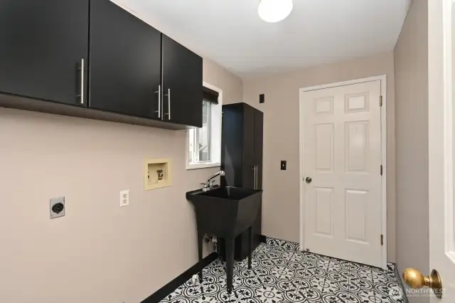 Laundry room off the kitchen and door to the two car garage.