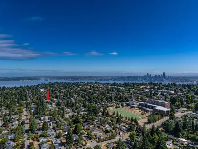 There is a video showing a 360 overhead drone viewpoint from the perspective of the home and where it sits in the neighborhood and the city of Seattle and surrounding points of interest: Alki, Mount Rainier, downtown, etc.