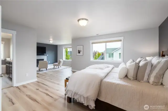 Oversized primary suite with large seating area and gas fireplace