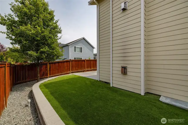 This faux grass in back is low maintenance, durable and pet waste friendly