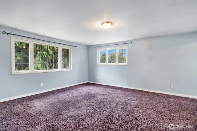 Expansive upper bedroom with north, south and west facing windows