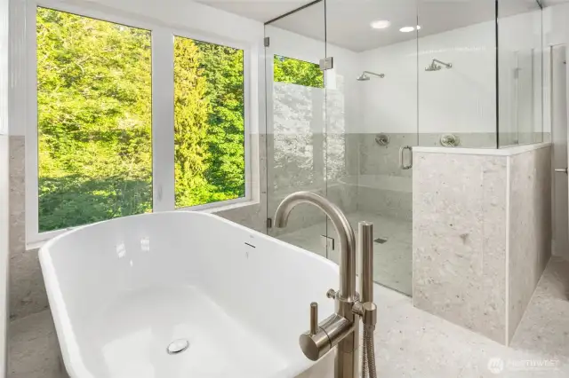 Soaking tub with a view and oversized shower with frameless glass surround