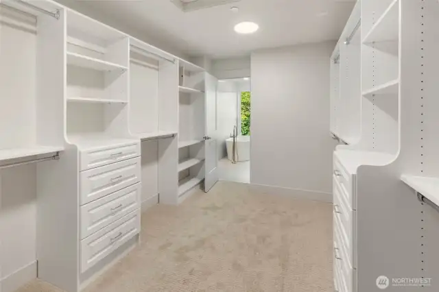 Expansive walk in closet with custom cabinets