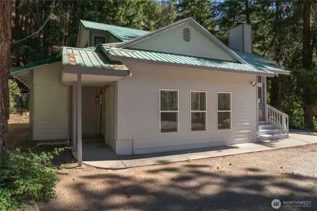 Enjoy a large family room with separate access to covered porch and wood shed.