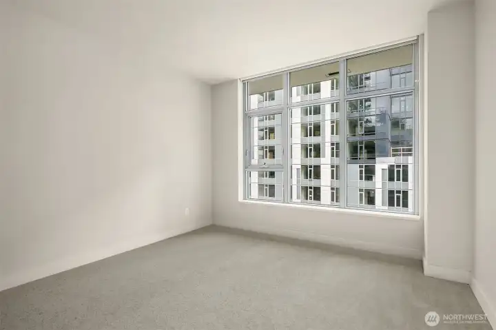 Large bedroom with walk-in closet and brand new carpet.