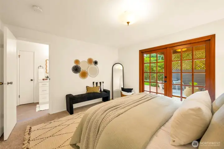 Primary bedroom with adjacent bath & French doors leading to the covered patio.