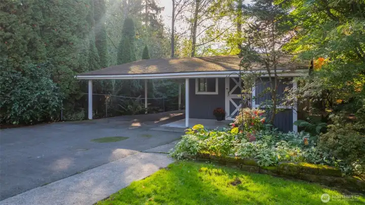 Picturesque "barn" with 2 car, covered carport, ample indoor storage & a carpeted, work-from-home office space.