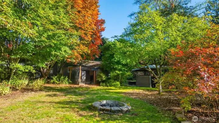 Fire pit for summer s'mores located near the back of this very private property.