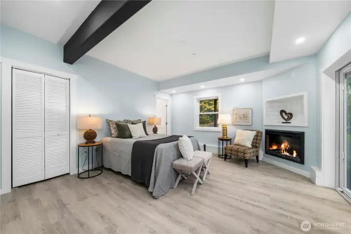 On the lower level, a gorgeous 2nd primary suite awaits, with a gas fireplace and views of sky and trees. The private luxury bath offers both a walk-in shower and separate soaking tub, plus a walk-in closet with shelving built right in. Step out through the slider to the serene back yard – a great spot to add a table and comfy chairs for your morning coffee.