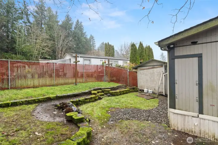 fully fenced backyard with storage shed