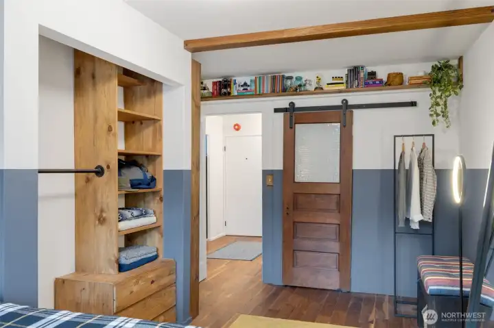 The seller added an opening into the bathroom creating an en suite bath and added a vintage door on a barn slider track.