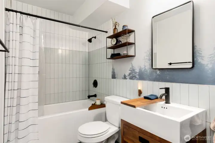 The bathroom got a full studs out remodel with a deep soaking tub, vertical tiles, all custom vanity and shelving.