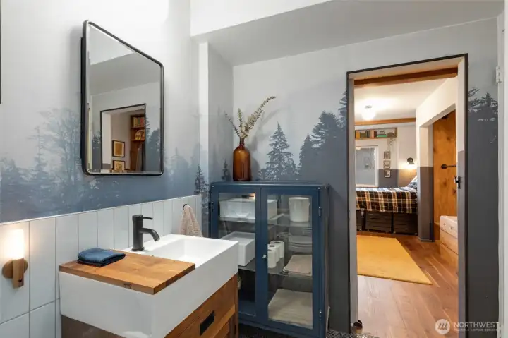 Lovely PNW wallpaper adds a serene touch to the bath.