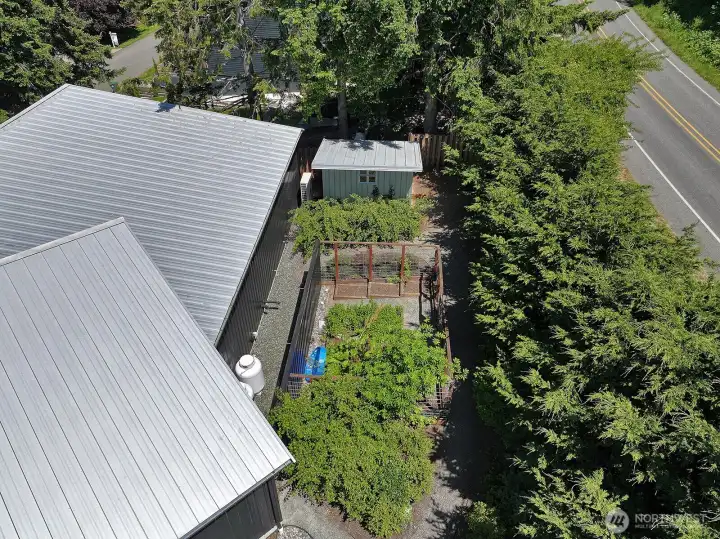Back yard offers a fenced garden space and outbuilding that could serve a higher purpose like a small shop or studio! Back yard offers a fenced garden space and outbuilding that could serve a higher purpose like a small shop or studio!