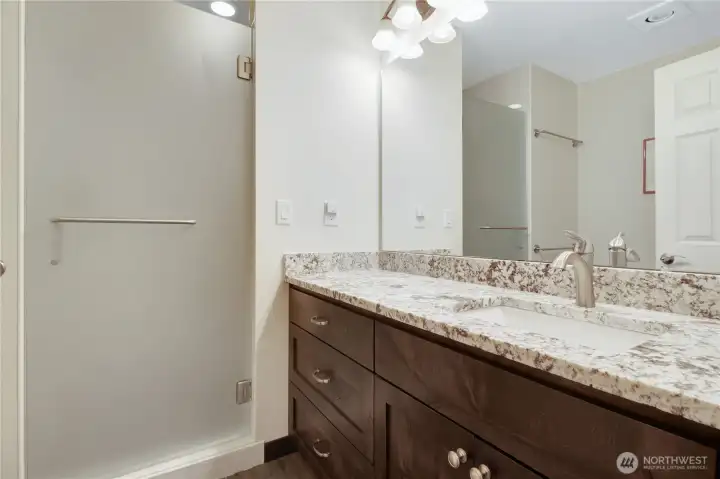 shared bathroom with matching quartz and cabinetry!