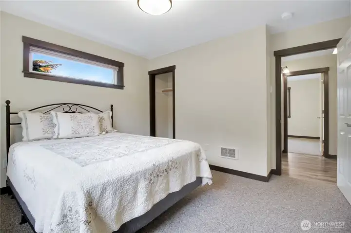 Closet space with bathroom and hallway to the right.