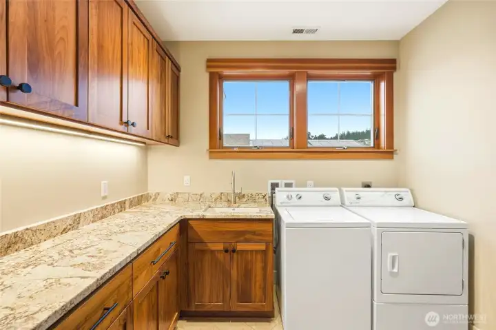 Quality materials continue in the large utility room. Cabinetry galore! Quality materials continue in the large utility room. Cabinetry galore!