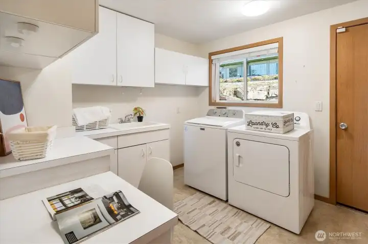The large laundry room connecting the attached garage to the den.