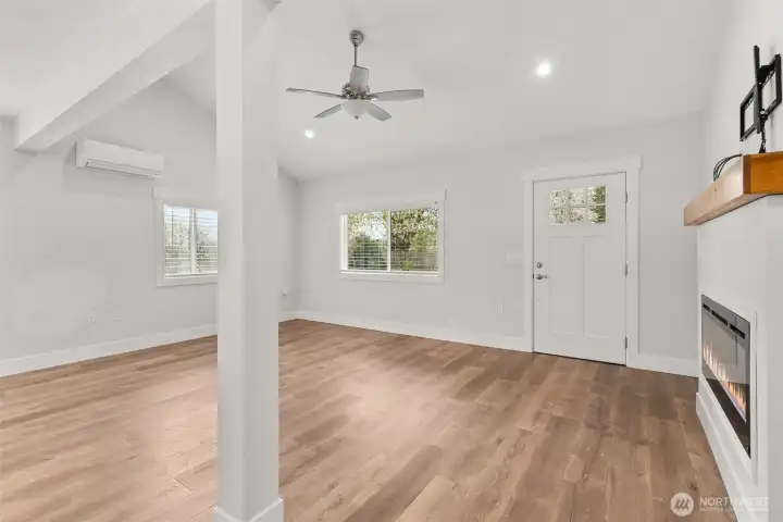 Light and bright living area with ceiling fan in the living room.