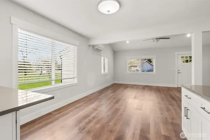 Dining area with built in cabinet and a quartz countertop for storage and display.