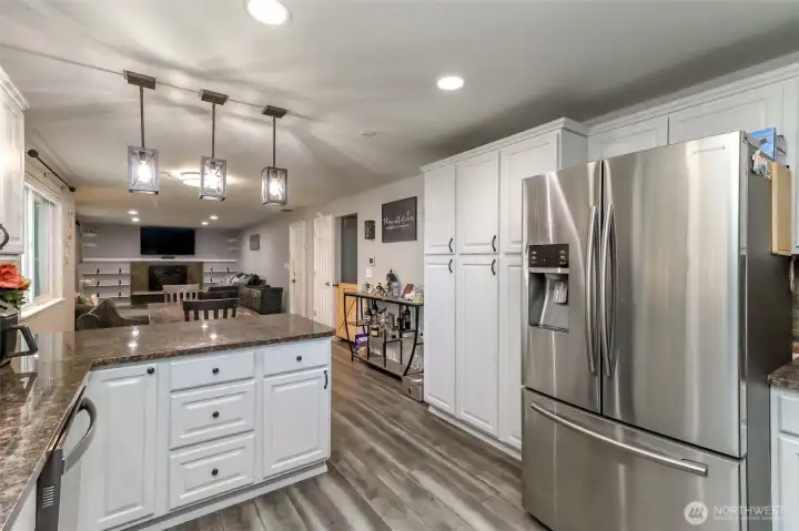 The great room accomodates kitchen counter eating space, dining room space and of the far end your hang out area with wood burning fireplace and double wide door entry into the living room! The great room accomodates kitchen counter eating space, dining room space and of the far end your hang out area with wood burning fireplace and double wide door entry into the living room!