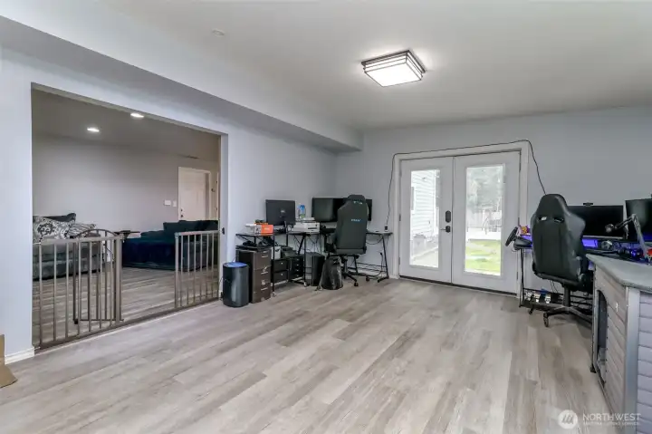 This is a picture of the living room with is currently used for an in home office and gym. The glass doors have built in blinds-the doors lead to the backyard lawn area. This is a picture of the living room with is currently used for an in home office and gym. The glass doors have built in blinds-the doors lead to the backyard lawn area.