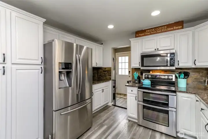 Here is a close up photos of the kitchen which there is a built in storage pantry on the left of the fridge and on the right of the fridge there is the perfect counter space for expresso/coffee machine-notice the entry into the mudd room. Here is a close up photos of the kitchen which there is a built in storage pantry on the left of the fridge and on the right of the fridge there is the perfect counter space for expresso/coffee machine-notice the entry into the mudd room.