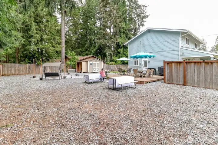 This view of the side yard shows the entertainment sized deck which is accessible from the mudd room but also the living room. This view of the side yard shows the entertainment sized deck which is accessible from the mudd room but also the living room.