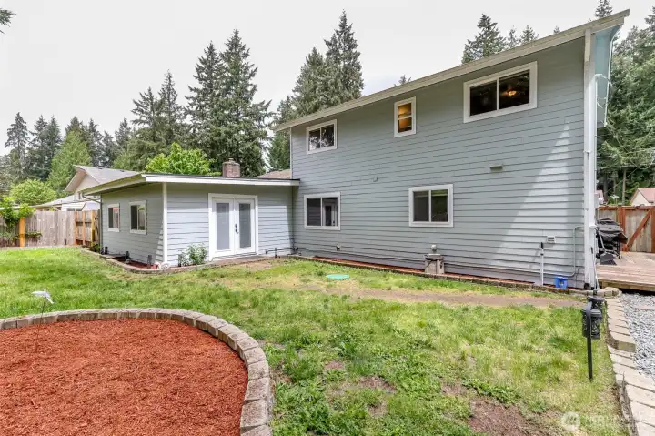 The backyard has lawn space for plan and there is concrete blocks to create a border for the flower beds. The backyard has lawn space for plan and there is concrete blocks to create a border for the flower beds.