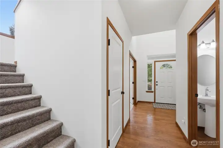 A partial view of the half bathroom down the hallway from the entrance. Across is a large closet. Upstairs are the bedrooms.