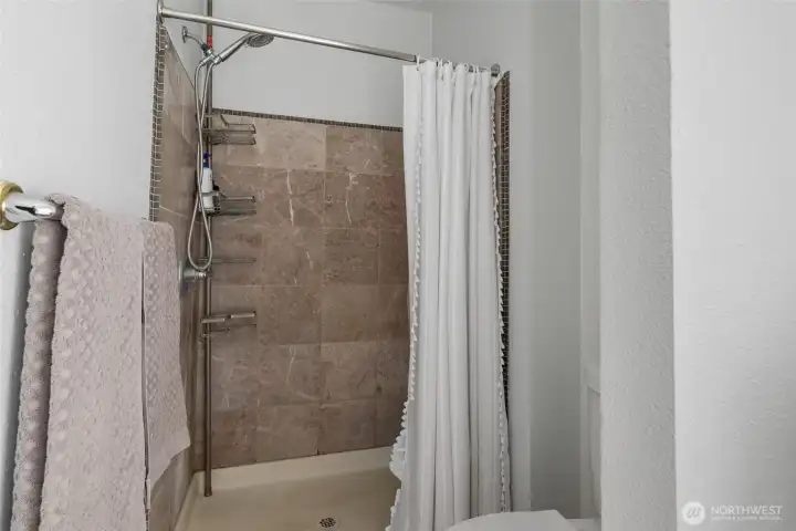 Separate tiled in shower in the primary bathroom. Separate tiled in shower in the primary bathroom.