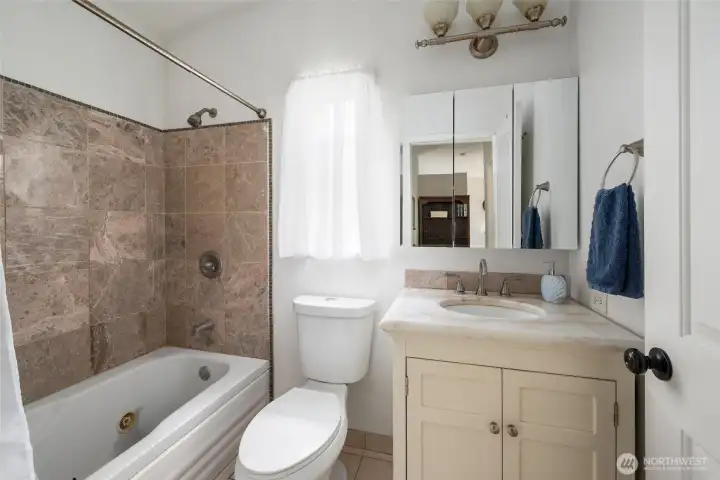 Hall bathroom, notice the jetted tub and tile surround. Hall bathroom, notice the jetted tub and tile surround.