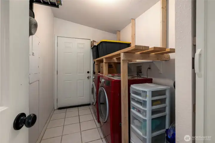Laundry room with door to backyard and heavy duty built in shelves. Laundry room with door to backyard and heavy duty built in shelves.