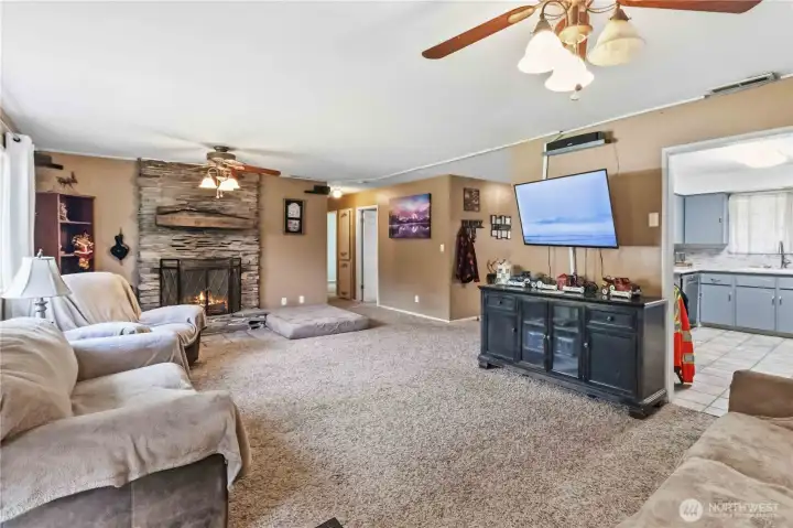 Warm, open & inviting living room with wood burning fireplace. Warm, open & inviting living room with wood burning fireplace.