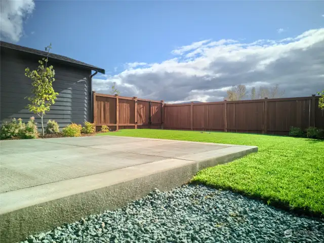 Fenced backyard and patio for primary dwelling.